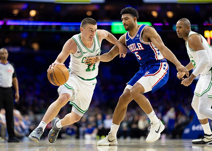 Feb 20, 2025; Philadelphia, Pennsylvania, USA; Boston Celtics guard Payton Pritchard (11) drives against Philadelphia 76ers guard Quentin Grimes (5) during the second quarter at Wells Fargo Center. Mandatory Credit: Bill Streicher-Imagn Images