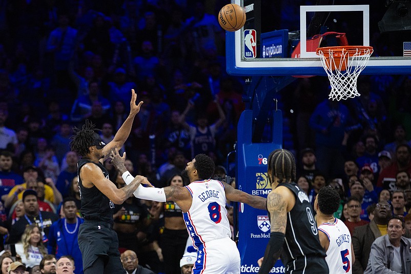 Feb 22, 2025; Philadelphia, Pennsylvania, USA; Brooklyn Nets center Nic Claxton (33) scores the game winning shot past Philadelphia 76ers forward Paul George (8) as time expires at Wells Fargo Center. Mandatory Credit: Bill Streicher-Imagn Images