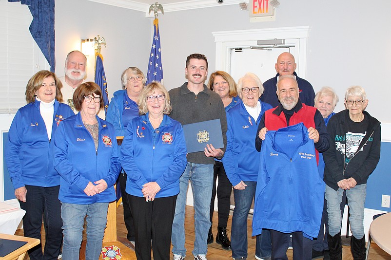 Sea Isle City Police Officer Trent Markley (holding plaque) and Sea Isle Mayor Leonard Desiderio (holding jacket) are shown with several of VFW Post 1963 Auxiliary’s officers while being honored during the Auxilary’s February meeting. Missing from the photo is Officer Grace Rutter. (Photo courtesy of Sea Isle City Public Relations)
