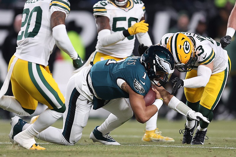 Jan 12, 2025; Philadelphia, Pennsylvania, USA; Philadelphia Eagles quarterback Jalen Hurts (1) rushes the ball agaistn Green Bay Packers safety Evan Williams (33) during the first half in an NFC wild card game at Lincoln Financial Field. Mandatory Credit: Bill Streicher-Imagn Images