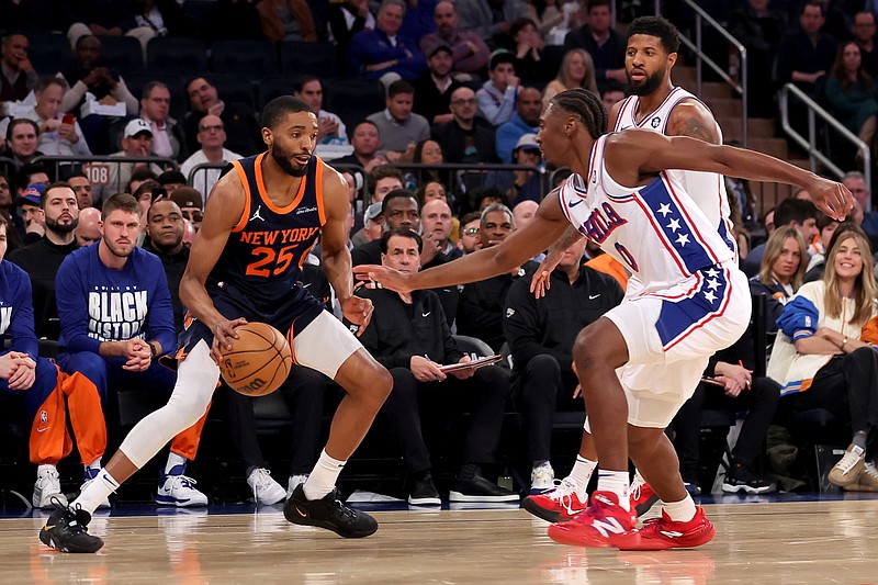 Feb 26, 2025; New York, New York, USA; New York Knicks forward Mikal Bridges (25) controls the ball against Philadelphia 76ers guard Tyrese Maxey (0) and forward Paul George (8) during the first quarter at Madison Square Garden. Mandatory Credit: Brad Penner-Imagn Images