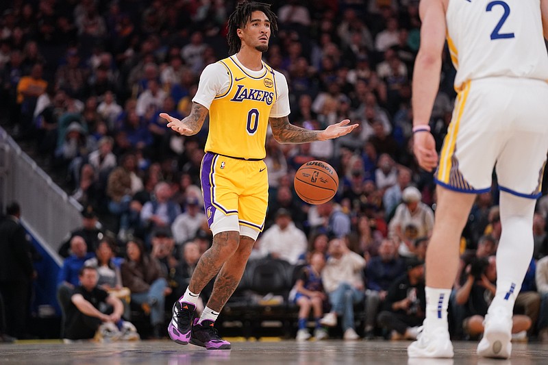 Oct 18, 2024; San Francisco, California, USA; Los Angeles Lakers guard Jalen Hood-Schifino (0) dribbles the ball up the court against the Golden State Warriors in the first quarter at the Chase Center. Mandatory Credit: Cary Edmondson-Imagn Images.