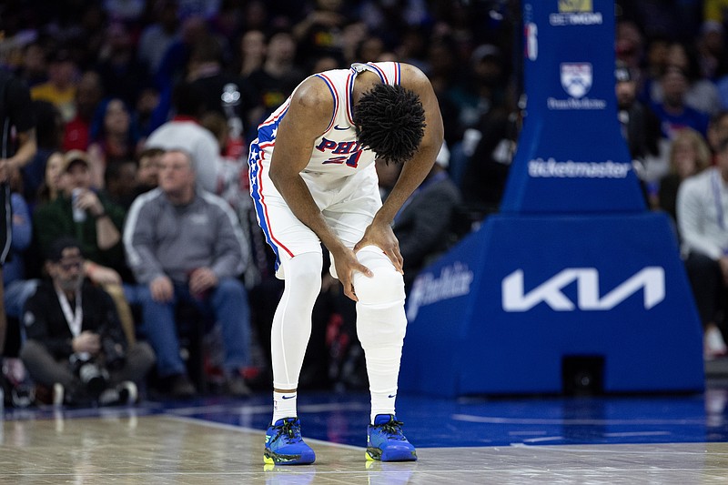 Feb 22, 2025; Philadelphia, Pennsylvania, USA; Philadelphia 76ers center Joel Embiid (21) holds his leg after a play against the Brooklyn Nets during the second quarter at Wells Fargo Center. Mandatory Credit: Bill Streicher-Imagn Images