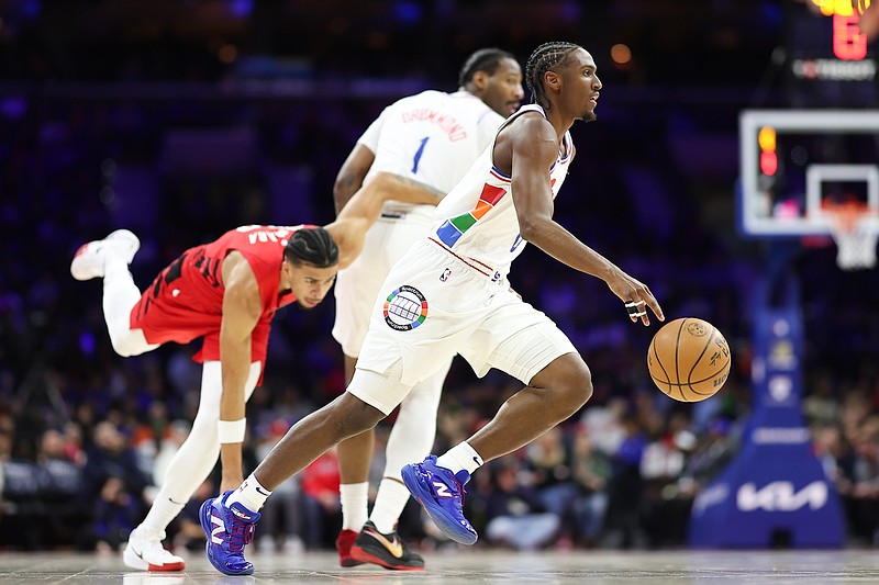 Mar 3, 2025; Philadelphia, Pennsylvania, USA; Philadelphia 76ers guard Tyrese Maxey (0) dribbles past Portland Trail Blazers forward Toumani Camara (33) during the first quarter at Wells Fargo Center. Mandatory Credit: Bill Streicher-Imagn Images