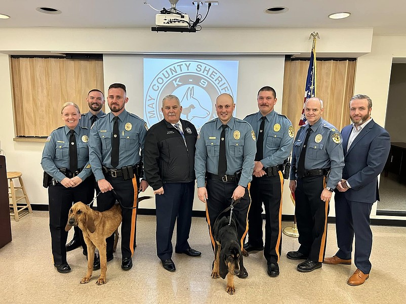 Cape May County Sheriff Bob Nolan, fourth from left, and his officers stand with two bloodhound K-9s. (Photo courtesy of Cape May County Sheriff's Office Facebook page)