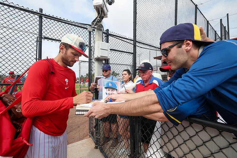 Feb 19, 2025; Clearwater, FL, USA; Philadelphia Phillies shortstop Trea Turner (7) signs autographs for fans during  spring training workouts at BayCare Ballpark. Mandatory Credit: Nathan Ray Seebeck-Imagn Images