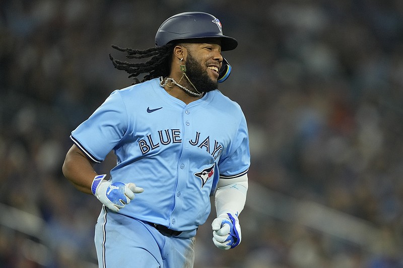 Apr 28, 2024; Toronto, Ontario, CAN; Toronto Blue Jays designated hitter Vladimir Guerrero Jr. (27) smiles as he runs to first base on a single against the Los Angeles Dodgers during the eighth inning at Rogers Centre. Mandatory Credit: John E. Sokolowski-USA TODAY Sports