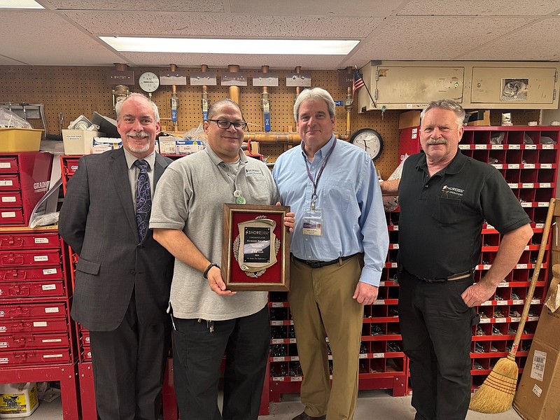 Shore Medical Center Employee of the Year Herminio DeLaRosa holds his award while joined by Bob Robertson, senior director of Logistics, Plant Operations and 
Maintenance, Brad Foltz, director of Plant Operations and Maintenance, and Jim Crawford, Maintenance and Electrical supervisor. (Photo courtesy of Shore Medical Center)