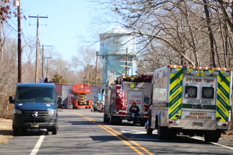 Emergency vehicles line Mill Road in Tuckahoe next to the film shoot in the background.