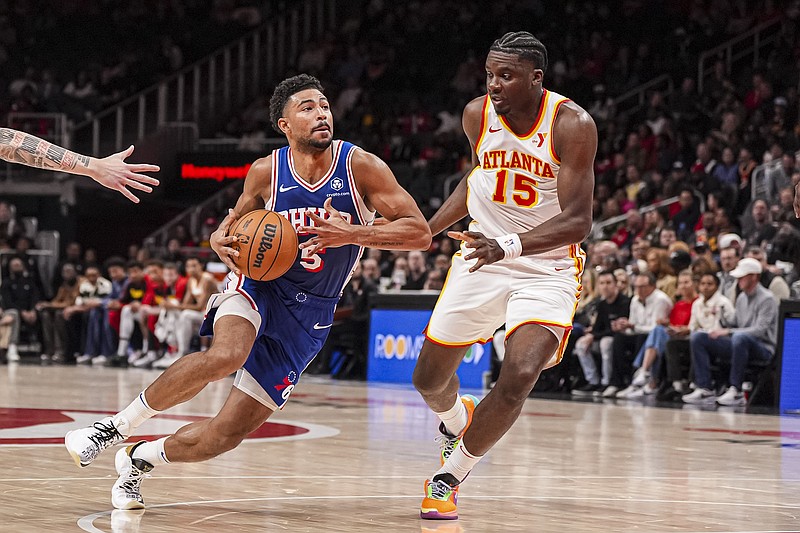 Mar 10, 2025; Atlanta, Georgia, USA; Philadelphia 76ers guard Quentin Grimes (5) drives to the basket against Atlanta Hawks center Clint Capela (15) during the first half at State Farm Arena. Mandatory Credit: Dale Zanine-Imagn Images