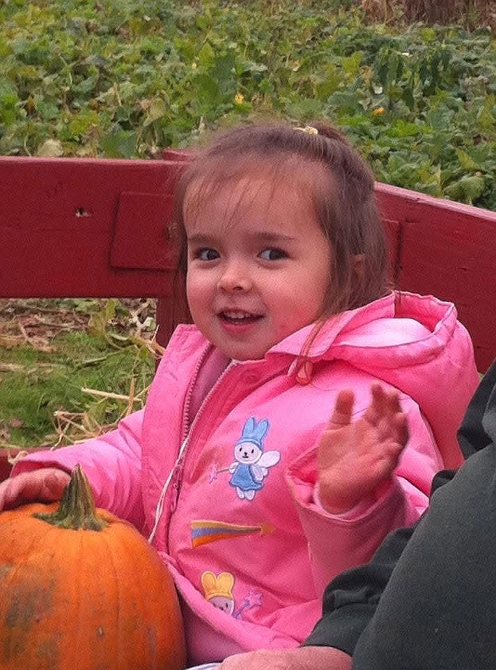 Ash Finley, then age 3, selecting her pumpkin at Freddy Hill Farms in 2011.