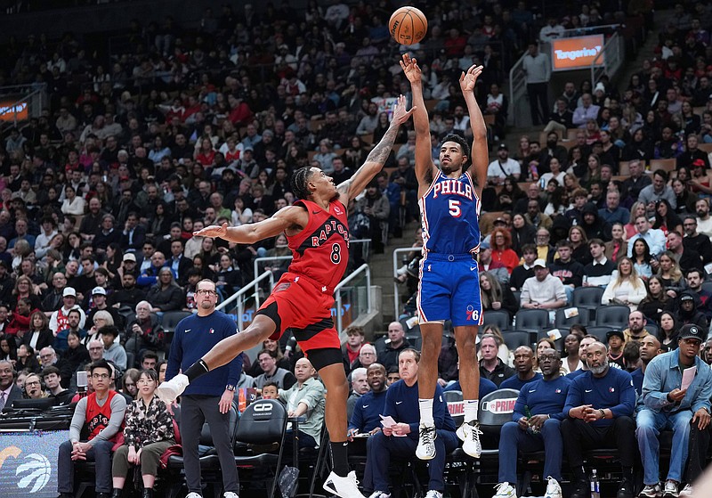 Mar 12, 2025; Toronto, Ontario, CAN; Philadelphia 76ers guard Quentin Grimes (5) shoots the ball as Toronto Raptors guard Jared Rhoden (8) tries to defend during the second quarter at the Scotiabank Arena. Mandatory Credit: Nick Turchiaro-Imagn Images