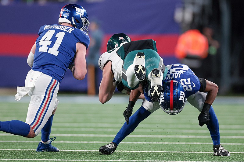 Jan 7, 2024; East Rutherford, New Jersey, USA; Philadelphia Eagles tight end Grant Calcaterra (81) is tackled by New York Giants linebacker Micah McFadden (41) and cornerback Adoree' Jackson (22) after a catch during the second half at MetLife Stadium. Mandatory Credit: Vincent Carchietta-USA TODAY Sports