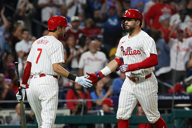 Sep 9, 2024; Philadelphia, Pennsylvania, USA; Philadelphia Phillies designated hitter Kyle Schwarber (12) shakes hands with shortstop Trea Turner (7) after hitting a solo home run during the sixth inning against the Tampa Bay Rays at Citizens Bank Park. Mandatory Credit: Bill Streicher-Imagn Images