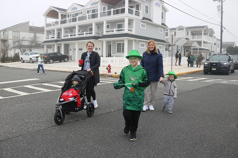 Tripp Christensen shows off his colorful St. Patrick's Day outfit while leading his family down Landis Avenue to watch the parade.