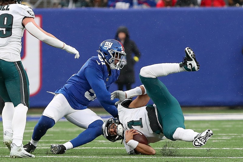 Dec 11, 2022; East Rutherford, New Jersey, USA; Philadelphia Eagles quarterback Jalen Hurts (1) is sacked by New York Giants linebacker Azeez Ojulari (51) during the fourth quarter at MetLife Stadium. Mandatory Credit: Tom Horak-USA TODAY Sports