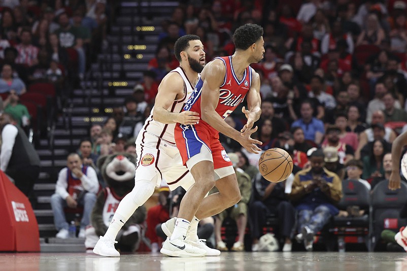 Mar 17, 2025; Houston, Texas, USA; Houston Rockets guard Fred VanVleet (5) attempts to get control of the ball away from Philadelphia 76ers guard Quentin Grimes (5) during the second quarter at Toyota Center. Mandatory Credit: Troy Taormina-Imagn Images