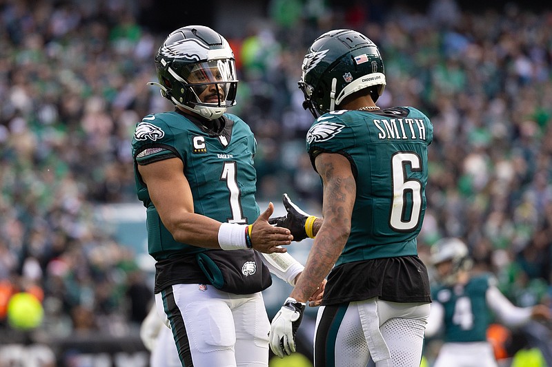 Dec 8, 2024; Philadelphia, Pennsylvania, USA;  Philadelphia Eagles wide receiver DeVonta Smith (6) and quarterback Jalen Hurts (1) celebrate their touchdown connection against the Carolina Panthers during the second quarter at Lincoln Financial Field. Mandatory Credit: Bill Streicher-Imagn Images