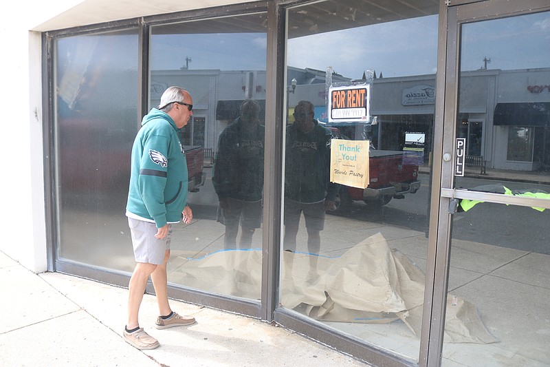 Councilman Keith Hartzell looks inside the former Wards Pastry shop on Asbury Avenue.