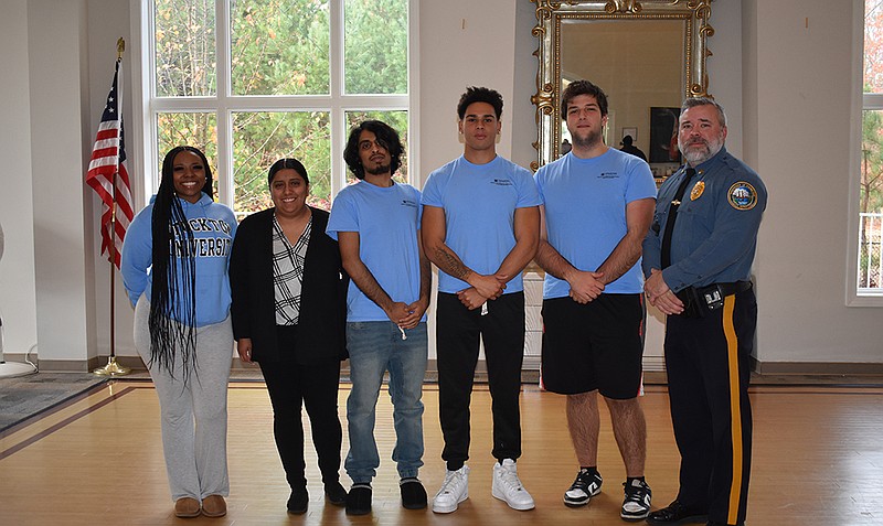 STOCKTON/Criminal Justice Professor Jess Bonnan-White's undergraduate students with Sgt. Craig Clayton of the Hamilton Township Police Department during a community meeting in Hamilton Township. From left, Sierra Hicks, Stephanie Gonzalez, Nahid Rahman, Ryder Anagnos, Zachary Maikisch and Clayton.