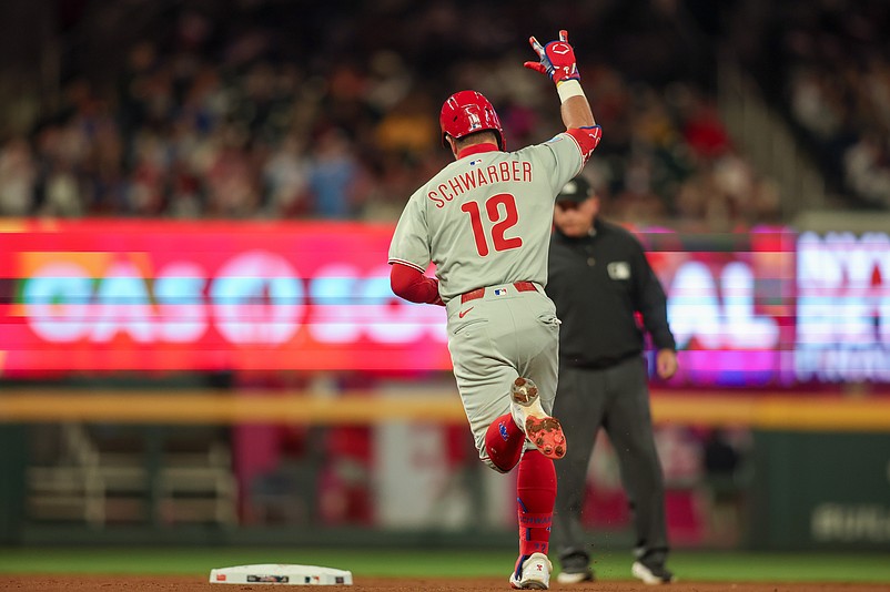 Apr 8, 2025; Atlanta, Georgia, USA; Philadelphia Phillies designated hitter Kyle Schwarber (12) hits a home run against the Atlanta Braves in the fifth inning at Truist Park. Mandatory Credit: Brett Davis-Imagn Images