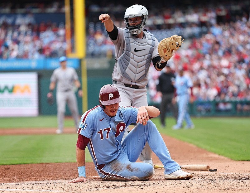 Apr 3, 2025; Philadelphia, Pennsylvania, USA; Colorado Rockies catcher Jacob Stallings (25) tags out Philadelphia Phillies outfielder Max Kepler (17) at the plate during the second inning at Citizens Bank Park. Mandatory Credit: Bill Streicher-Imagn Images