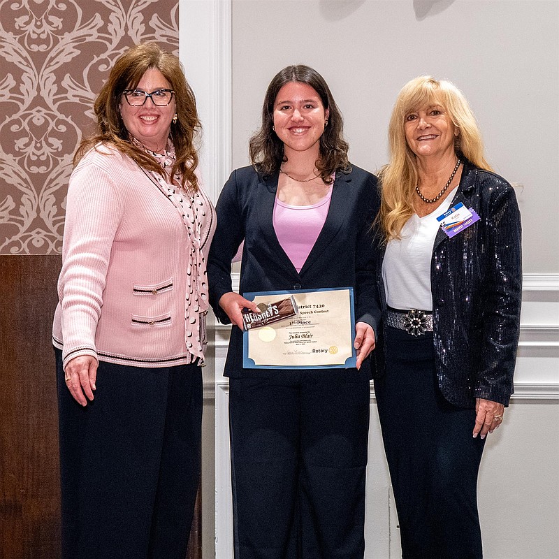Julia Blair, center, with her certificate. (Credit: Rotary International)