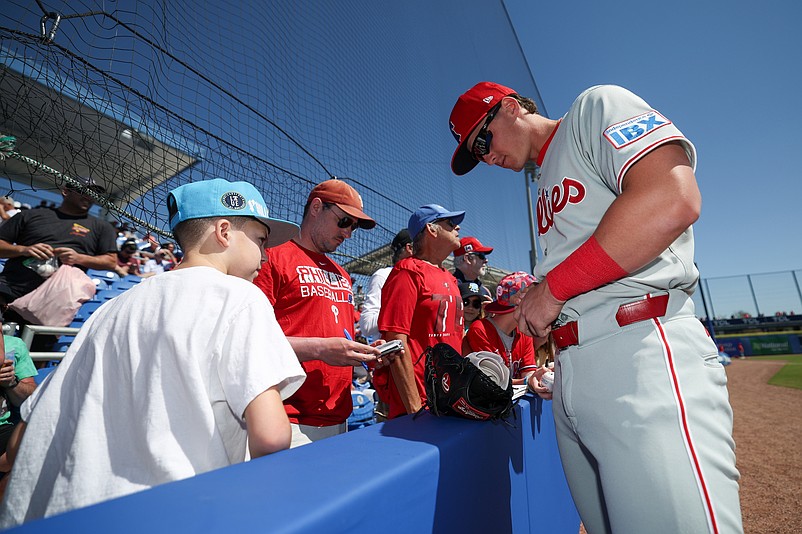 Mar 2, 2025; Dunedin, Florida, USA; Philadelphia Phillies infielder Aidan Miller (81) signs autographs for fans before a game against the Toronto Blue Jays during spring training at TD Ballpark. Mandatory Credit: Nathan Ray Seebeck-Imagn Images
