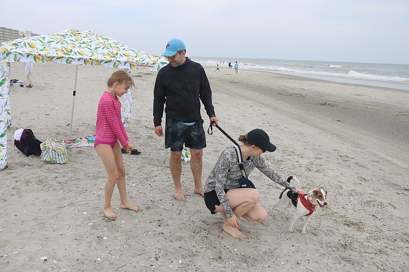 Philadelphia residents Kelly and David Janke and their daughter, Lorraine, and dog, Enola, enjoy their holiday weekend on the Sea Isle City beach.