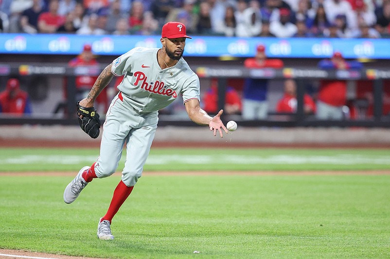 Apr 22, 2025; New York City, New York, USA;  Philadelphia Phillies starting pitcher Cristopher S‡nchez (61) flips the ball to first base in the first inning New York Mets at Citi Field. Mandatory Credit: Wendell Cruz-Imagn Images