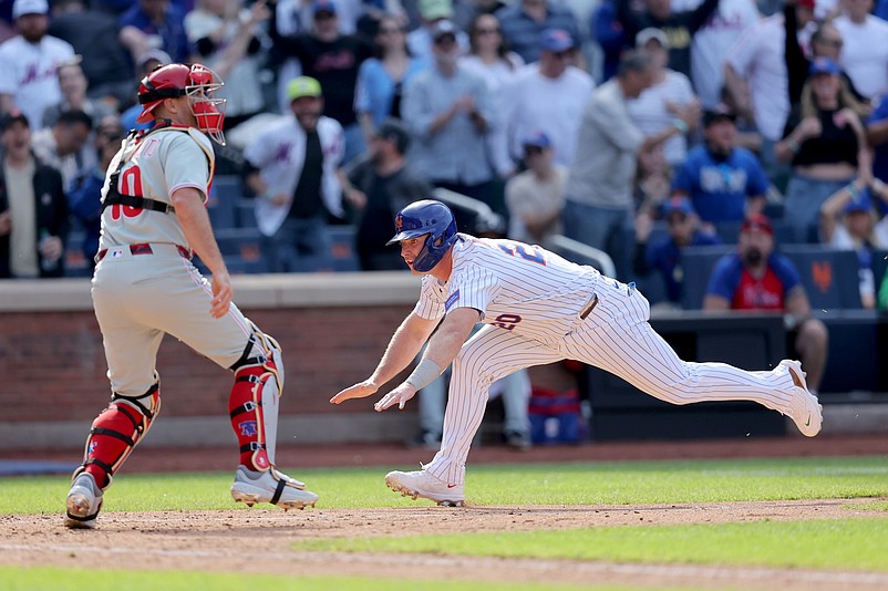 Apr 23, 2025; New York City, New York, USA; New York Mets first baseman Pete Alonso (20) scores the game winning run against Philadelphia Phillies catcher J.T. Realmuto (10) on a walkoff single by designated hitter Starling Marte (not pictured) during the tenth inning at Citi Field. Mandatory Credit: Brad Penner-Imagn Images