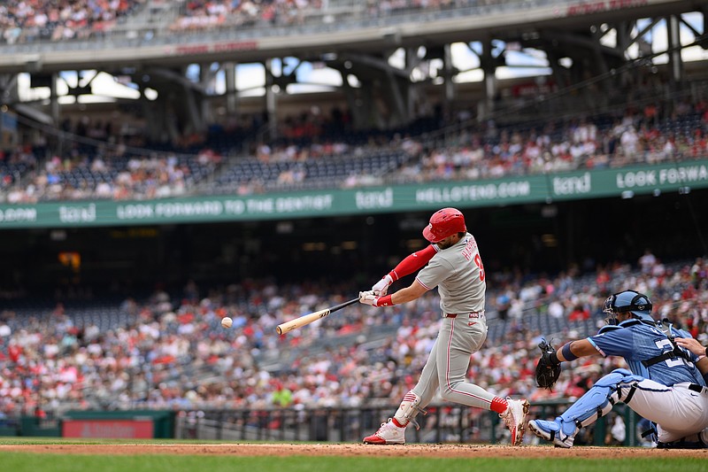 Mar 29, 2025; Washington, District of Columbia, USA; Philadelphia Phillies first baseman Bryce Harper (3) hits a single during the third inning against the Washington Nationals at Nationals Park. Mandatory Credit: Reggie Hildred-Imagn Images