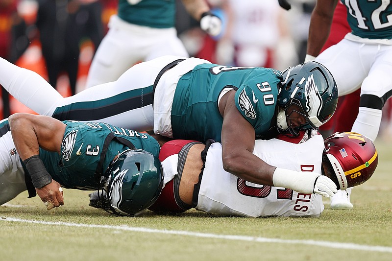 Jan 26, 2025; Philadelphia, PA, USA; Philadelphia Eagles defensive tackle Jordan Davis (90) and linebacker Nolan Smith Jr. (3) tackle Washington Commanders quarterback Jayden Daniels (5) during the first half of the NFC Championship game at Lincoln Financial Field. Mandatory Credit: Bill Streicher-Imagn Images