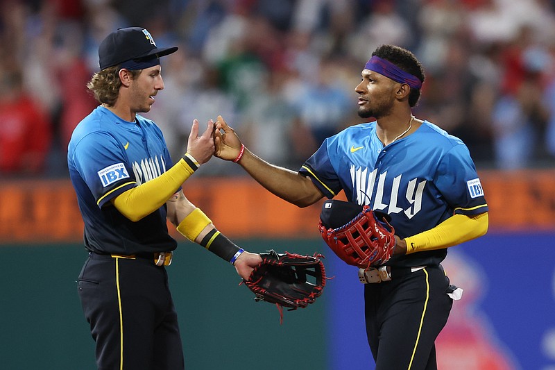 May 2, 2025; Philadelphia, Pennsylvania, USA; Philadelphia Phillies second base Bryson Stott (5) and outfielder Johan Rojas (23) high five after a victory against the Arizona Diamondbacks at Citizens Bank Park. Mandatory Credit: Bill Streicher-Imagn Images