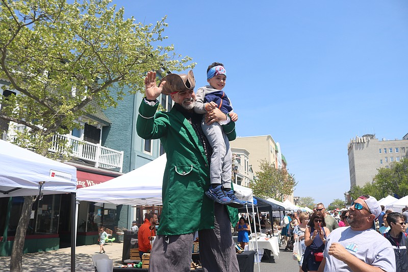 Stiltwalker Peter Donofrio gives 5-year-old Ryder Rusk a nice view of Asbury Avenue from 10 feet up during the 2025 Spring Block Party.
