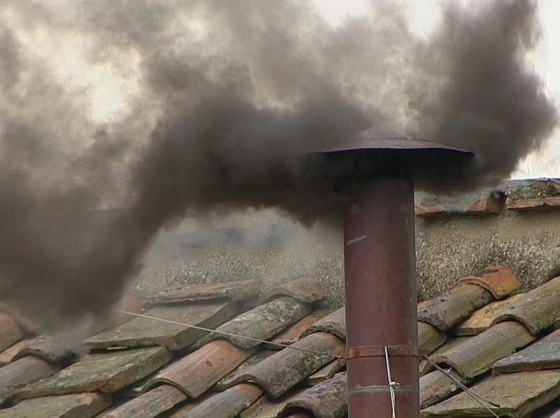 Black smoke billows out of the Vatican chimney, meaning there was not a consensus on a new pope during the first vote of Cardinals. (Credit: Reuters)
