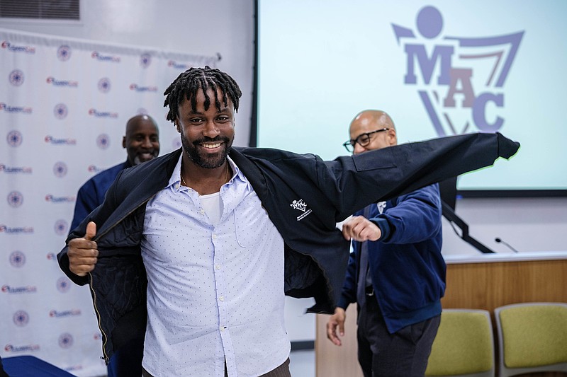 A MAC member receives his jacket.