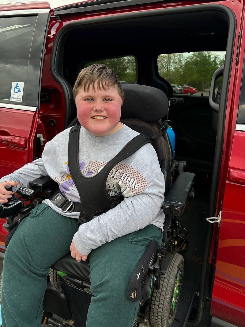 Killian "Kit" Bauer smiles as he exits his new van on his own.