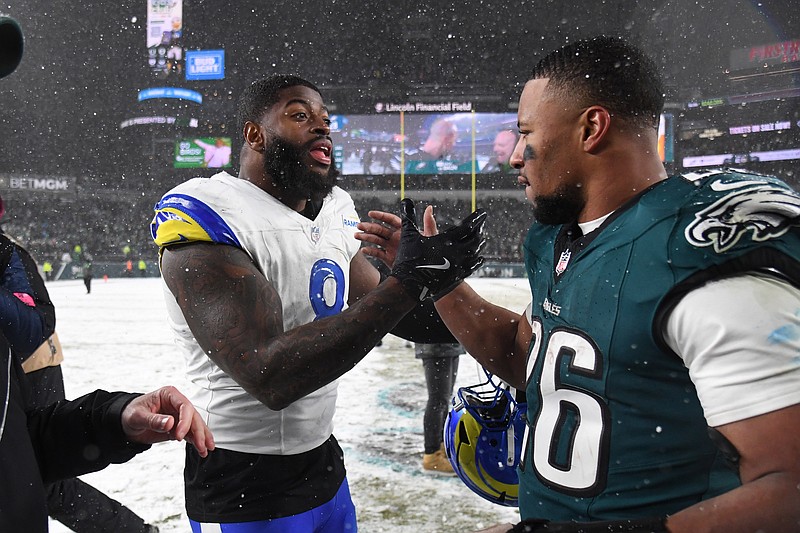 Jan 19, 2025; Philadelphia, Pennsylvania, USA; Los Angeles Rams linebacker Jared Verse (8) greets Philadelphia Eagles running back Saquon Barkley (26) after their 2025 NFC divisional round game at Lincoln Financial Field. Mandatory Credit: Eric Hartline-Imagn Images