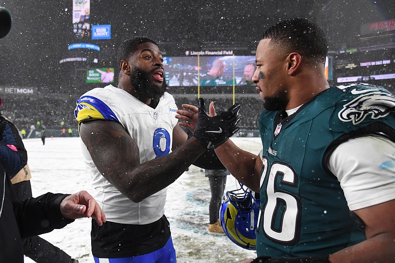 Jan 19, 2025; Philadelphia, Pennsylvania, USA; Los Angeles Rams linebacker Jared Verse (8) greets Philadelphia Eagles running back Saquon Barkley (26) after their 2025 NFC divisional round game at Lincoln Financial Field. Mandatory Credit: Eric Hartline-Imagn Images