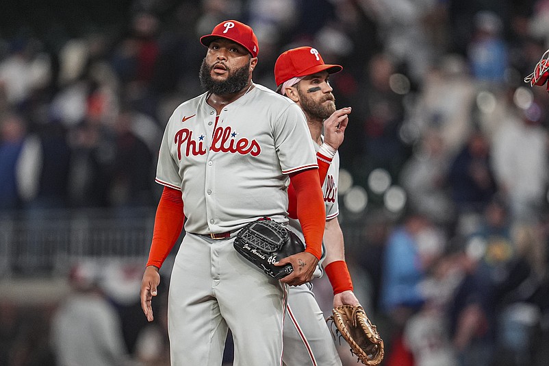 Apr 9, 2025; Cumberland, Georgia, USA; Philadelphia Phillies pitcher Jose Alvarado (46) reacts after shaking hands with first base Bryce Harper (3) after the Phillies defeated the Atlanta Braves at Truist Park. Mandatory Credit: Dale Zanine-Imagn Images