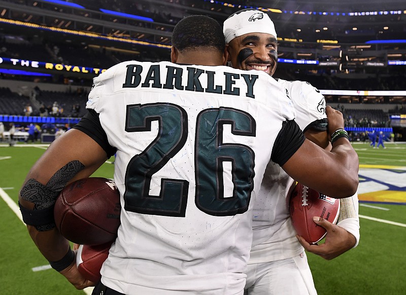 Nov 24, 2024; Inglewood, California, USA;  Philadelphia Eagles quarterback Jalen Hurts (1) hugs running back Saquon Barkley (26) in celebration after the Eagles defeat the Los Angeles Rams during the first half at SoFi Stadium. Mandatory Credit: Alex Gallardo-Imagn Images