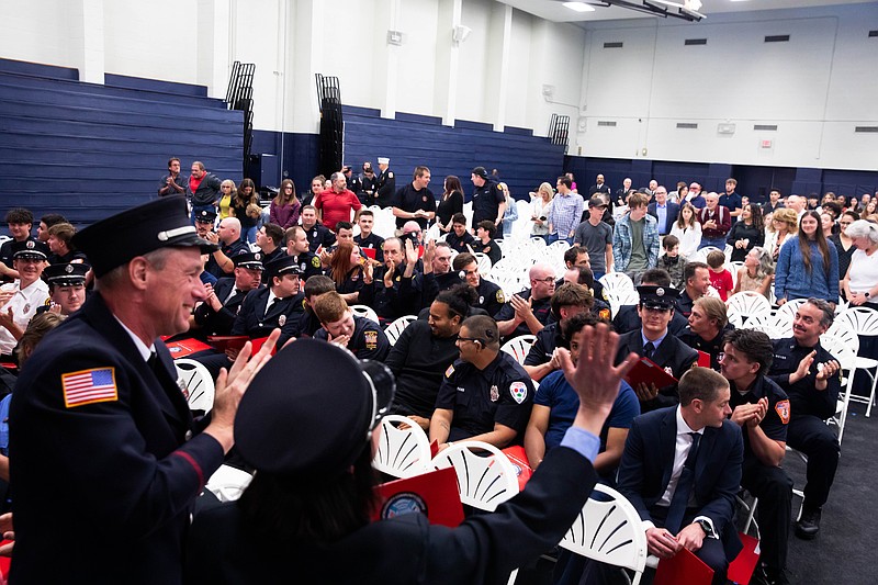Recent graduates greet fellow firefighters gathered in the gymnasium at Bucks County Community College’s Newtown Campus. The College’s Public Safety Training and Certification Department honored 90 volunteers who completed national firefighter certification training in a May 20 ceremony. (Credit: Eric Parker, BCCC)