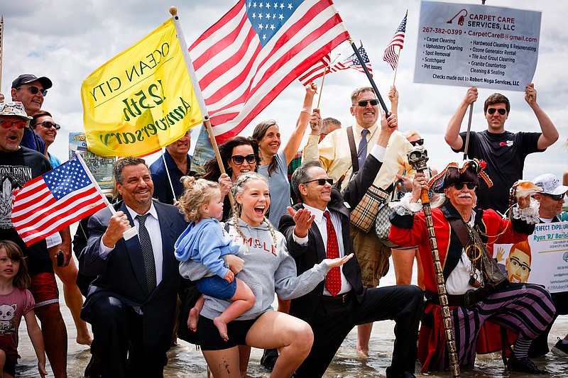 The business people pose for a triumphant photo after taking the plunge in 2025. (Photo courtesy of Kerri J Photography and Ocean City)