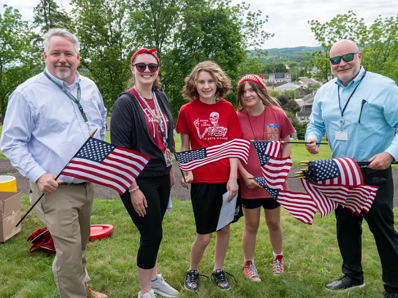 The annual tradition tasks North Middle School students, teachers and administrators with replenishing the American flags at the graves of Perkasie veterans. (Credit: David Thomas)