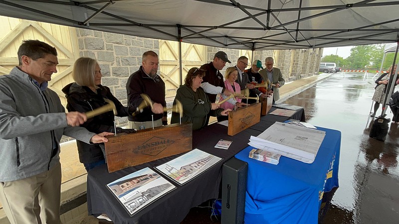 Discover Lansdale and borough visionaries hammer nails into old timber during the Lansdale Freight House groundbreaking May 22, 2025. From left are Ken Seiler of Ring Consulting Group, Helen Harlow Schwartz of Discover Lansdale, Lansdale Borough Public Works Director and Director of Community Development Jason Van Dame, Lansdale Borough President and Discover Lansdale Vice President Mary Fuller, Discover Lansdale President Bill Henning, State Sen. Maria Collett, State Rep. Steve Malagari, Discover Lansdale Secretary Bruce Schwartz, and Lansdale Borough Manager John Ernst.