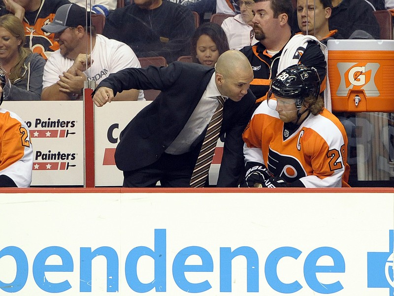 Oct 8, 2013; Philadelphia, PA, USA; Philadelphia Flyers assistant coach Ian Laperriere talk with Philadelphia Flyers center Claude Giroux (28) during the second period against the Florida Panthers at Wells Fargo Center. Mandatory Credit: Eric Hartline-USA TODAY Sports