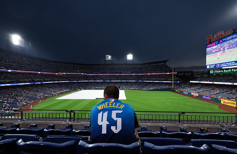May 16, 2025; Philadelphia, Pennsylvania, USA; A fan looks on during a rain delayed start between the Philadelphia Phillies and the Pittsburgh Pirates at Citizens Bank Park. Mandatory Credit: Bill Streicher-Imagn Images