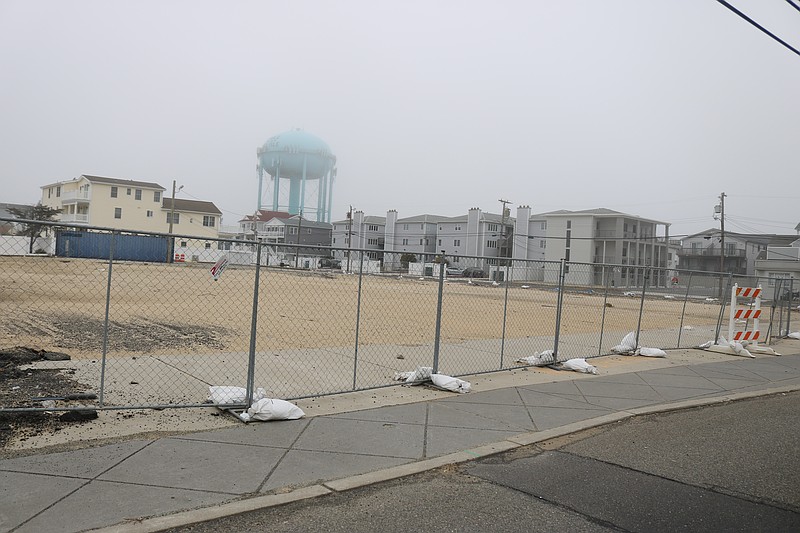 The former Ludlam Hotel site, now surrounded by a fence, overlooks Landis Avenue at the corner of John F. Kennedy Boulevard.