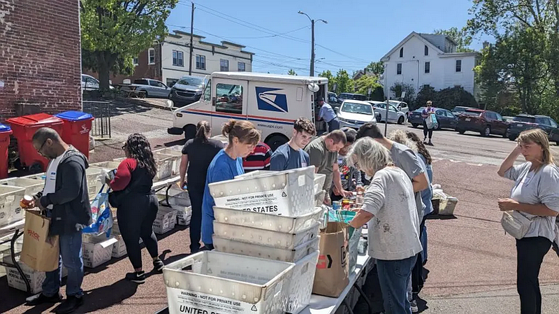 Keystone volunteers sort and process food donations delivered by local letter carriers as part of the Stamp Out Hunger food drive. (Credit: John Xuereb)